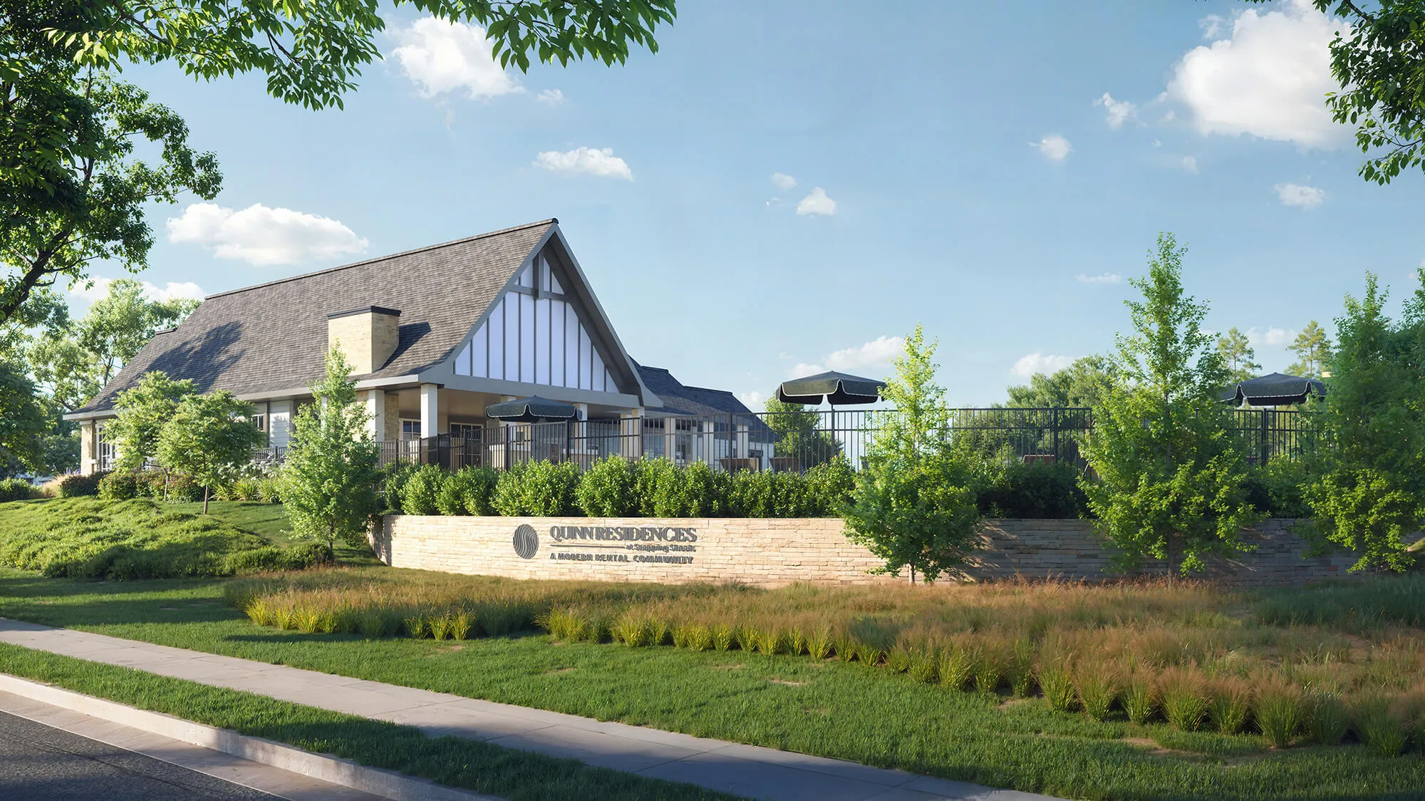 Modern community building with steep roof, patio umbrellas, lush greenery, and clear blue sky.