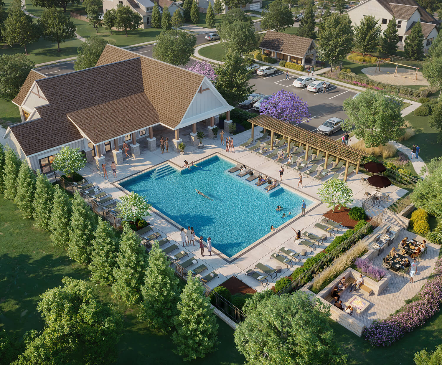 Aerial view of a community pool with people swimming, lounging, and a nearby outdoor seating area.