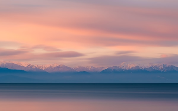 The Olympic Mountain range as seen from Deception Pass during sunrise in Washington.