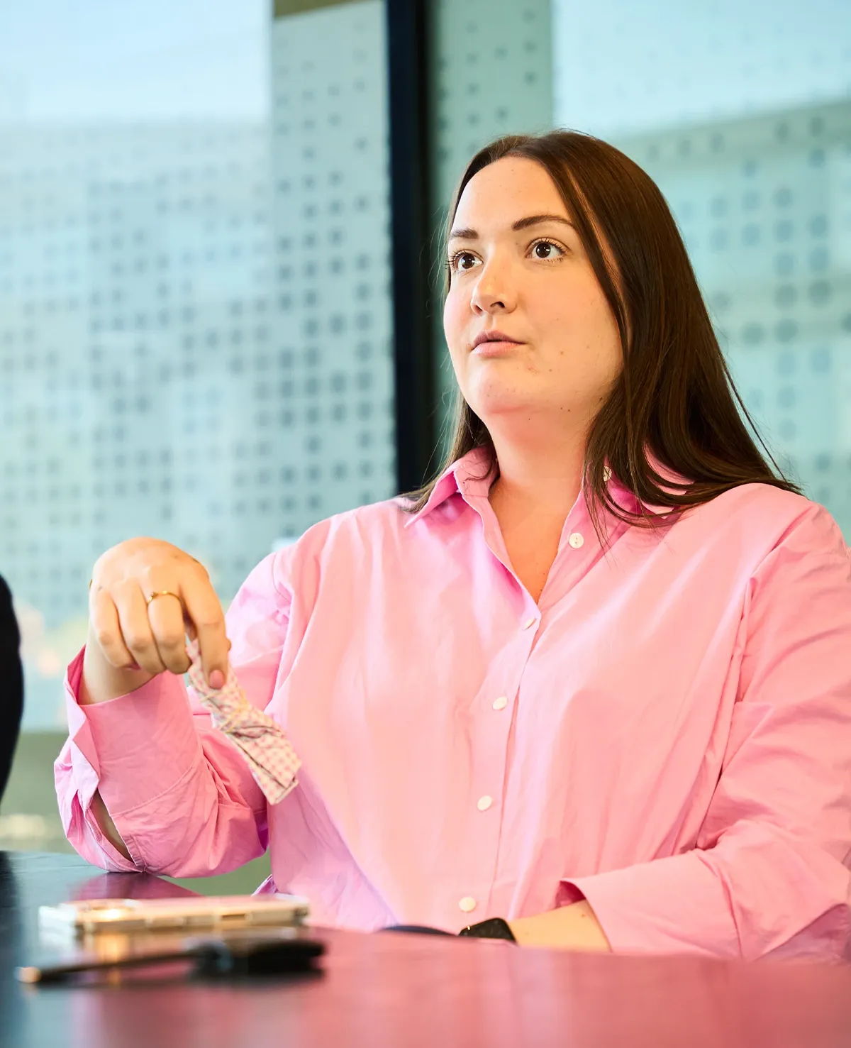Image of marketeer Elisa sat down in a meeting room.