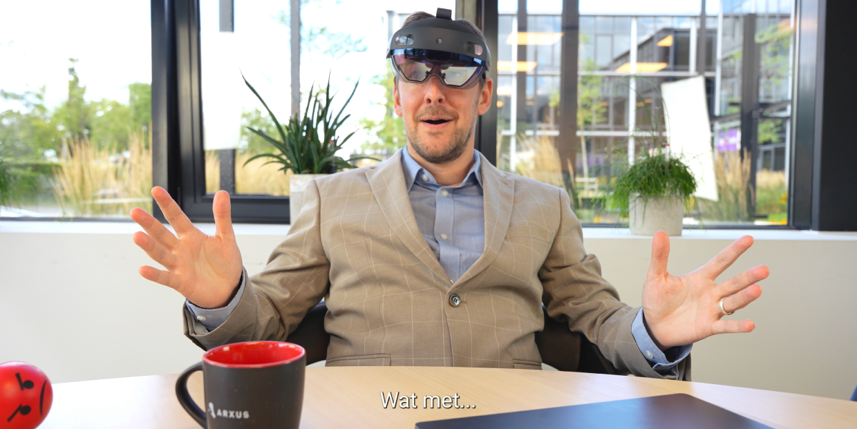 Still of the Arxus HR video showing the main actor sitting down with a VR set.