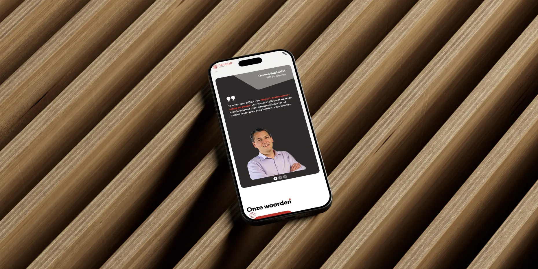 Mockup of the Bonanza Group website on a phone laying flat on a desk.