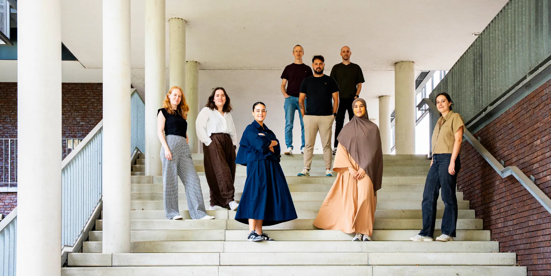 Posed photo of the enitre team of one of our clients, taken on some stairs outside.