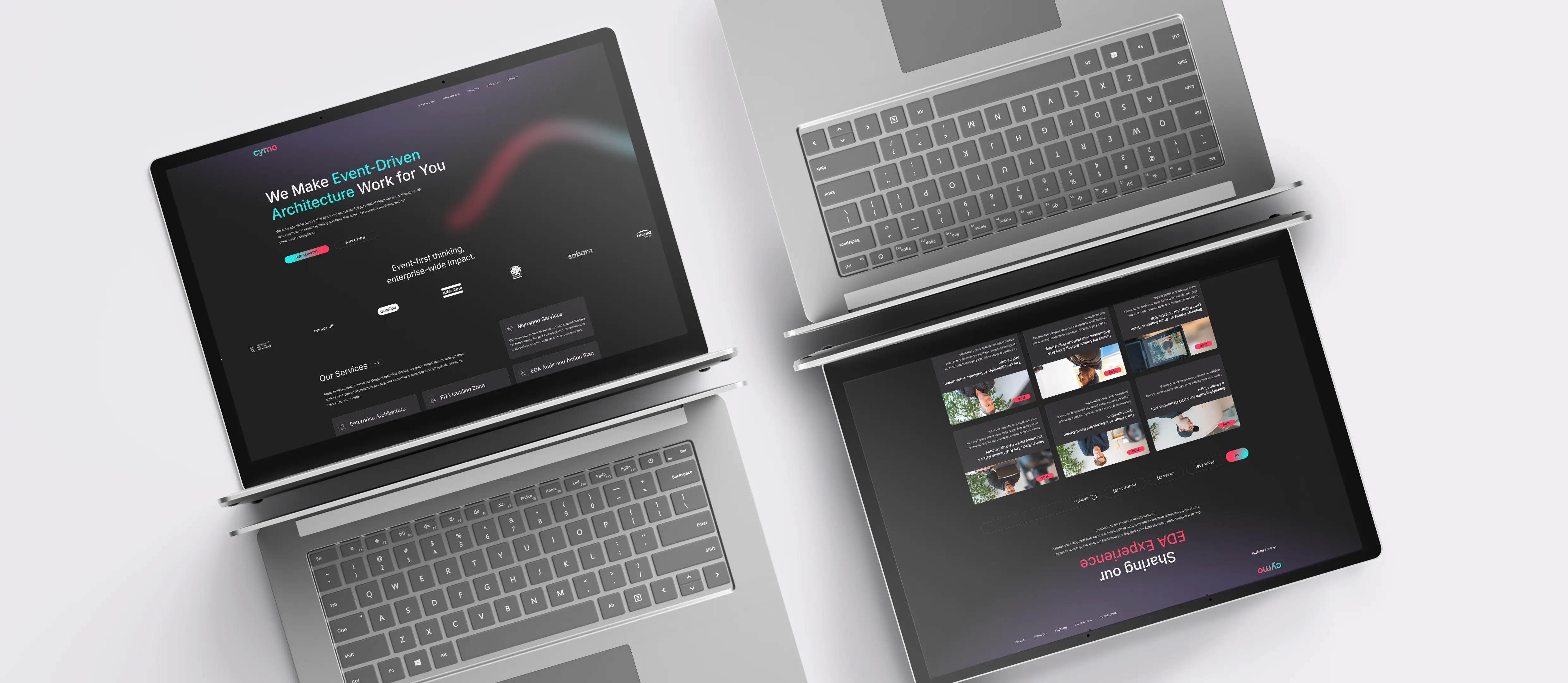 Mockup of two laptops, slightly roated and mirrored showing the homepage and the news overview pages on the Cymo website.