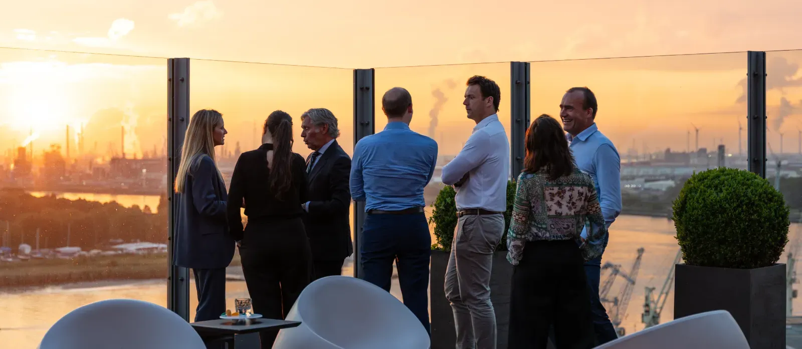 Photo taken by Unmute You during a meeting inside a conference room with some people sitting down and presenting up front.