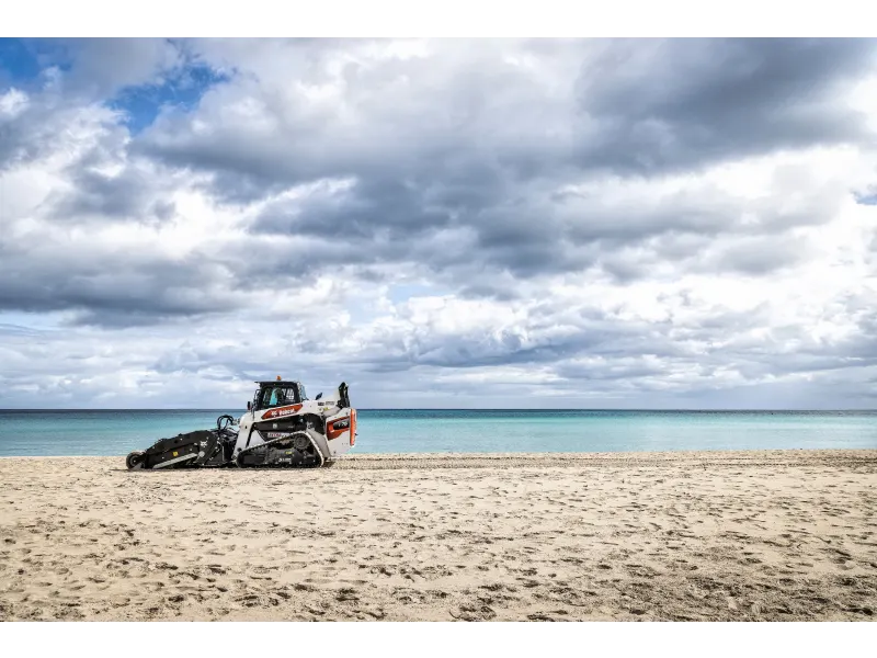 Sand sifting machine separating rocks from sweet soil using a screening bucket rental