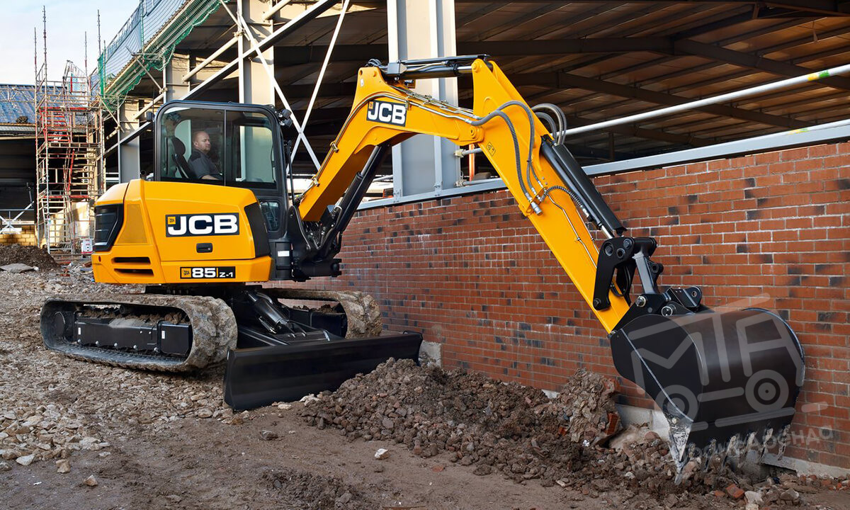 Digger and driver hire performing careful maneuvering on a villa patio