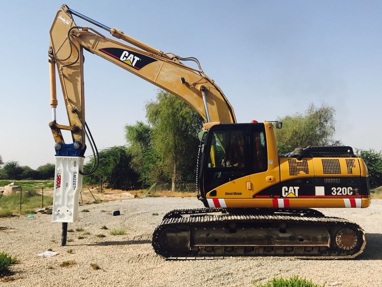 A heavy-duty piling rig performing pre-boring on a construction site, preparing the ground for displacement piles to reduce vibration.