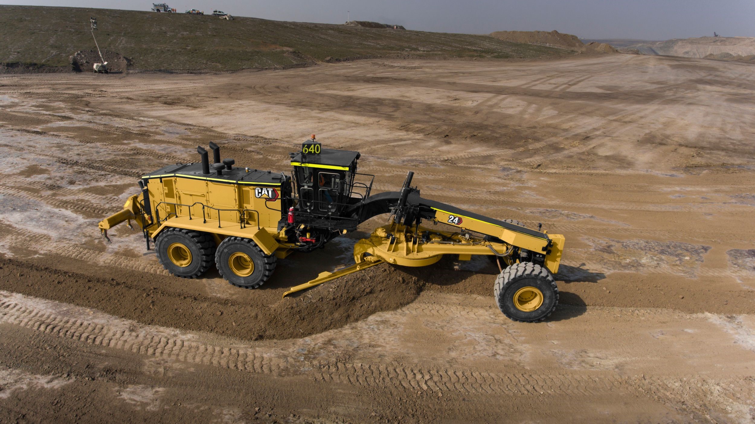 A Bobcat skid steer performing landscape leveling in a confined villa backyard, maneuvering around existing walls.