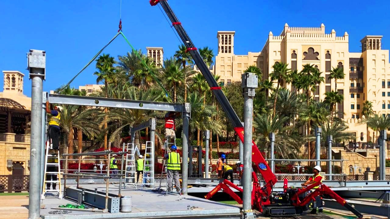 A specialized rigger securing a heavy AC unit with certified lifting slings and shackles, preparing for heavy lifting service.