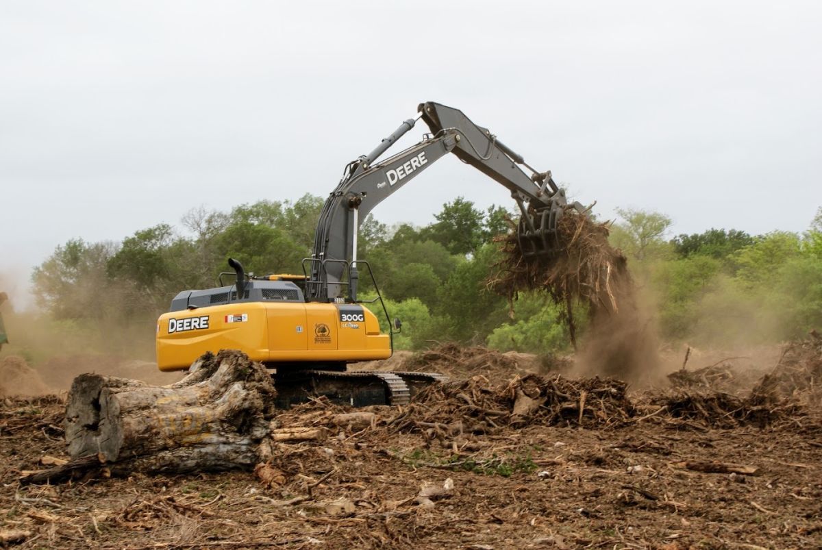 A fleet of BuildOra G heavy machinery including excavators and bobcats ready for construction site preparation.