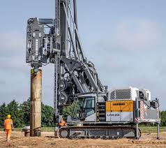 A top-down view of a secant pile wall under construction, showing the overlapping circles of primary and secondary piles drilled by a piling machine on rent.