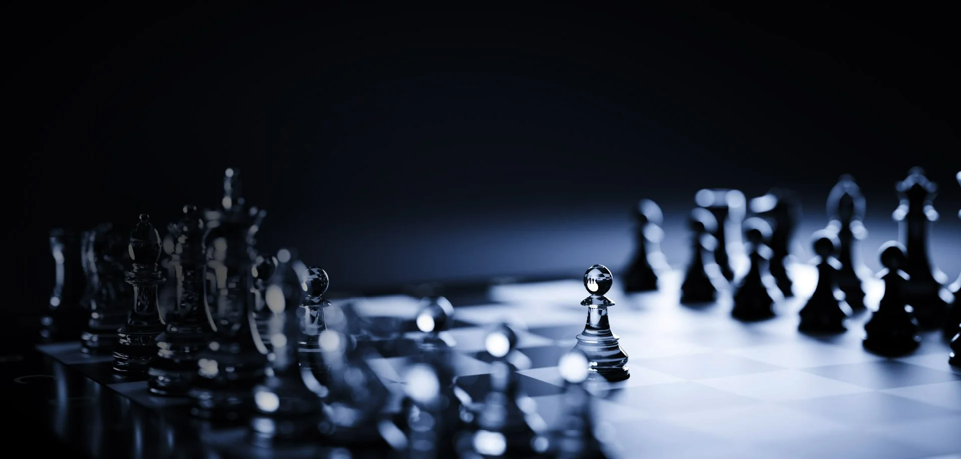 Close-up of a glass chessboard with a single pawn prominently standing in focus amid blurred chess pieces in dramatic lighting.