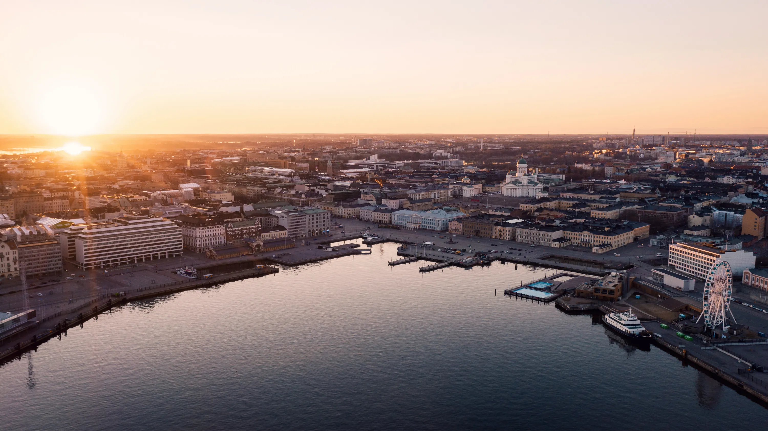 Aerial view of Helsinki, Finland at sunset with the Helsinki Cathedral visible.