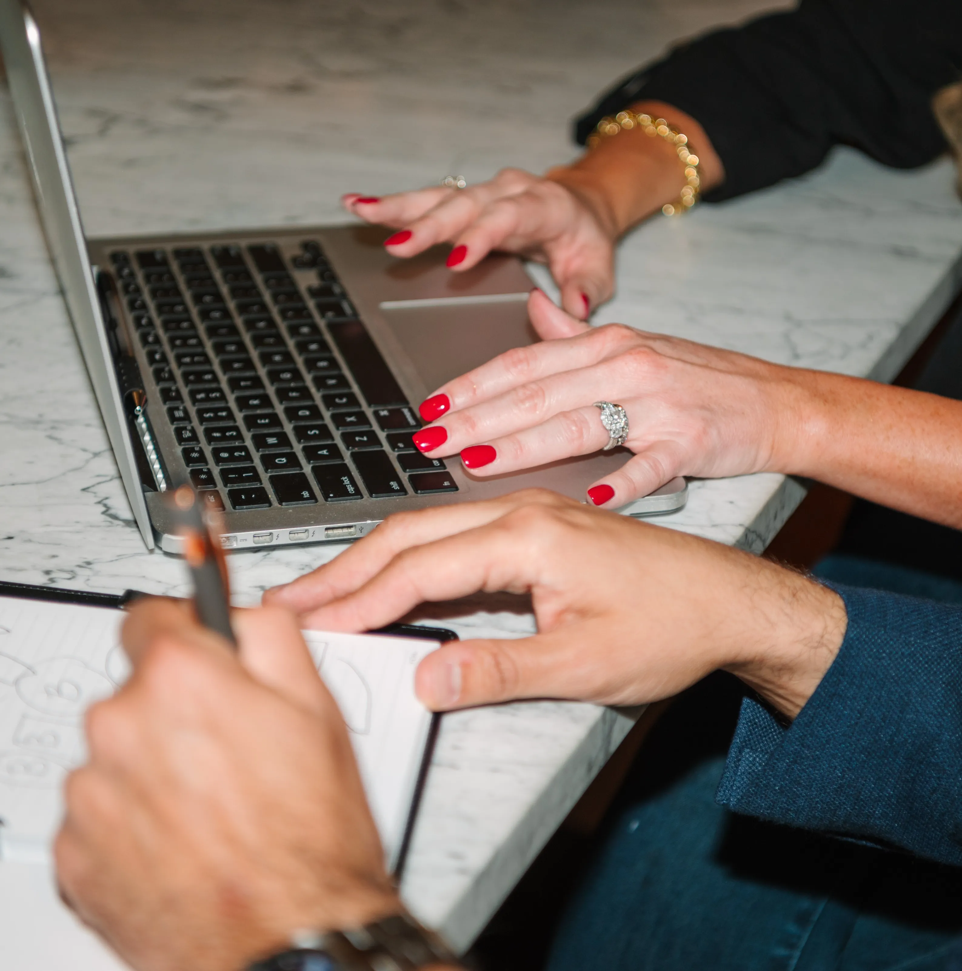 Close-up of hands typing on a laptop — Barrena Branding contact page