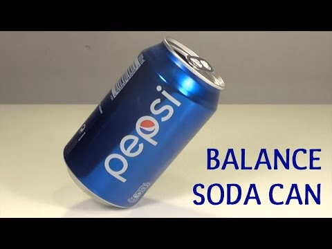 A blue Pepsi can balancing on its edge against a neutral background.