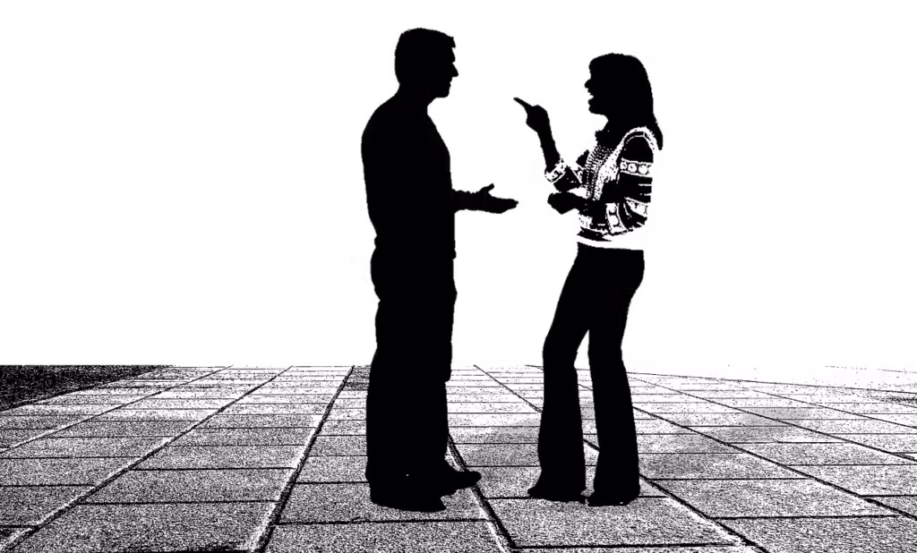 Two people stand facing each other, their figures silhouetted on a dark background atop a patterned stone surface.