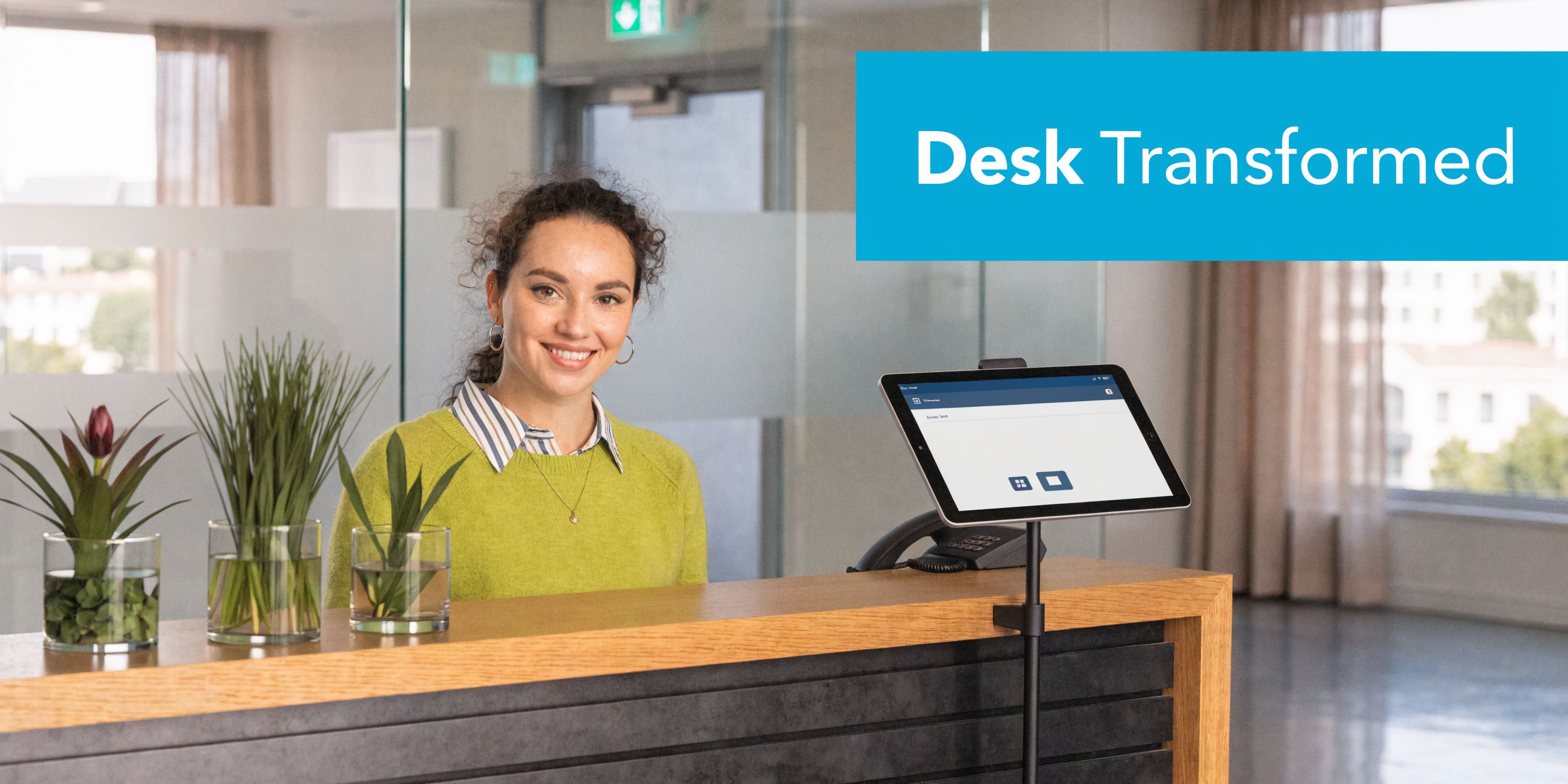 A smiling receptionist at a modern office desk using an AI-powered tablet for visitor management.