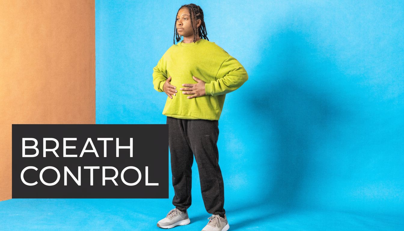 A person practicing proper breathing techniques with hands on their abdomen for improved vocal breath control.