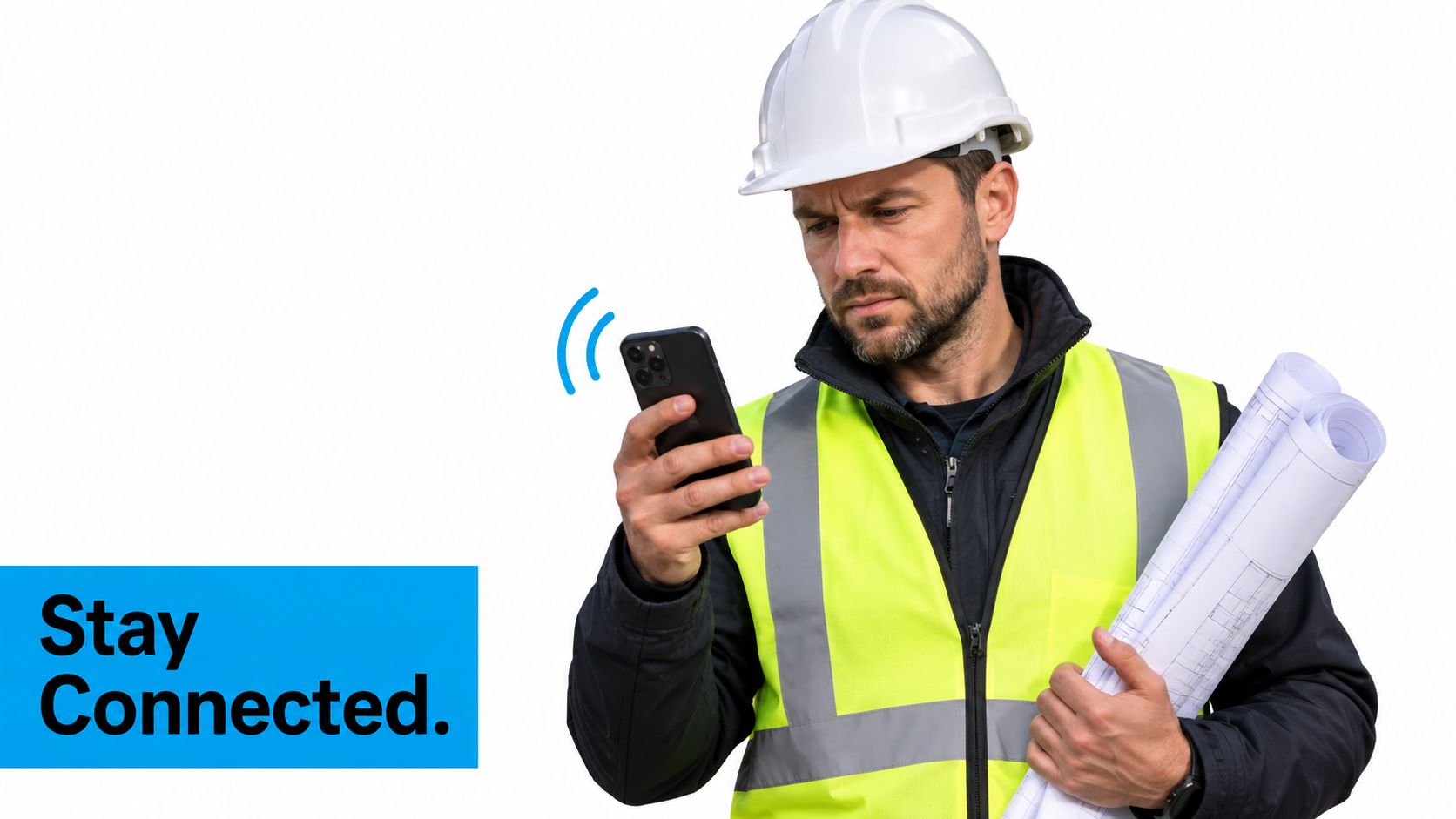 A construction worker in a hard hat and safety vest holding blueprints while looking at a smartphone.