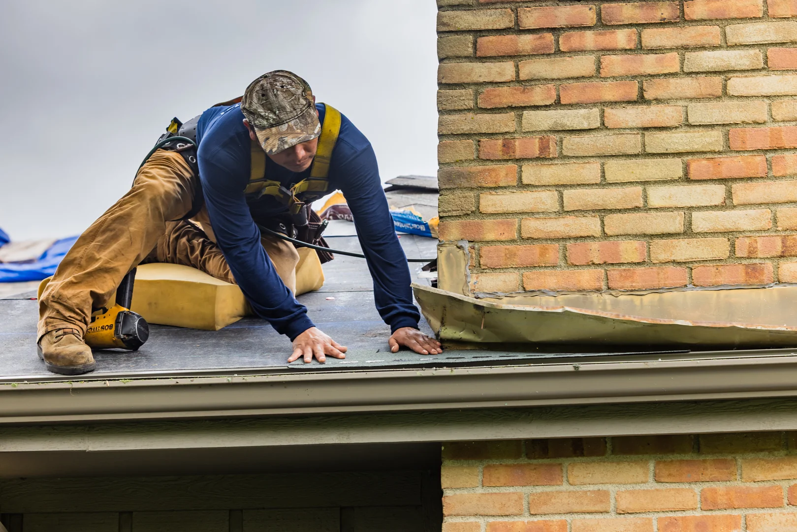 roof technician checking flashing and structural integrity