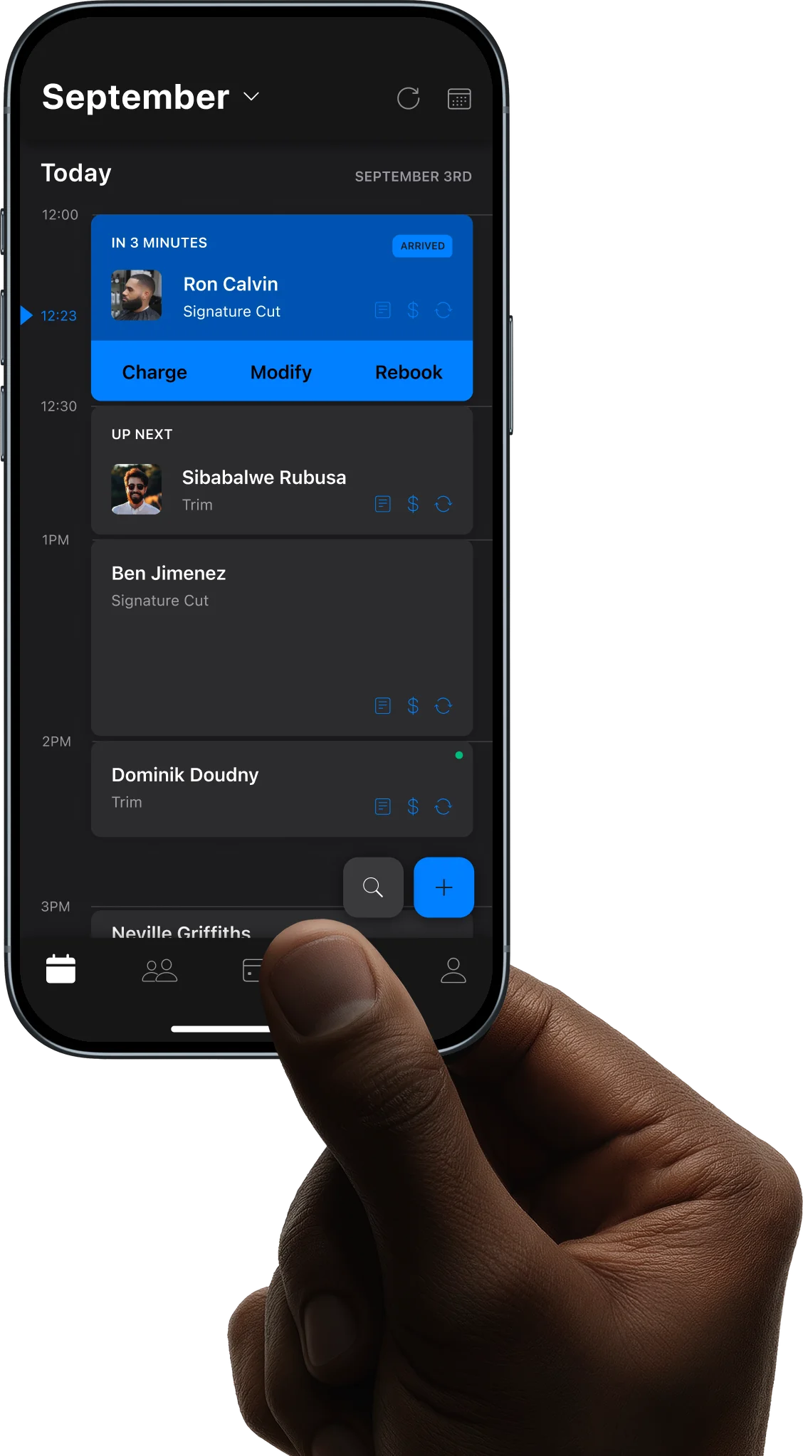 Hand holding an iPhone with a barber scheduling app