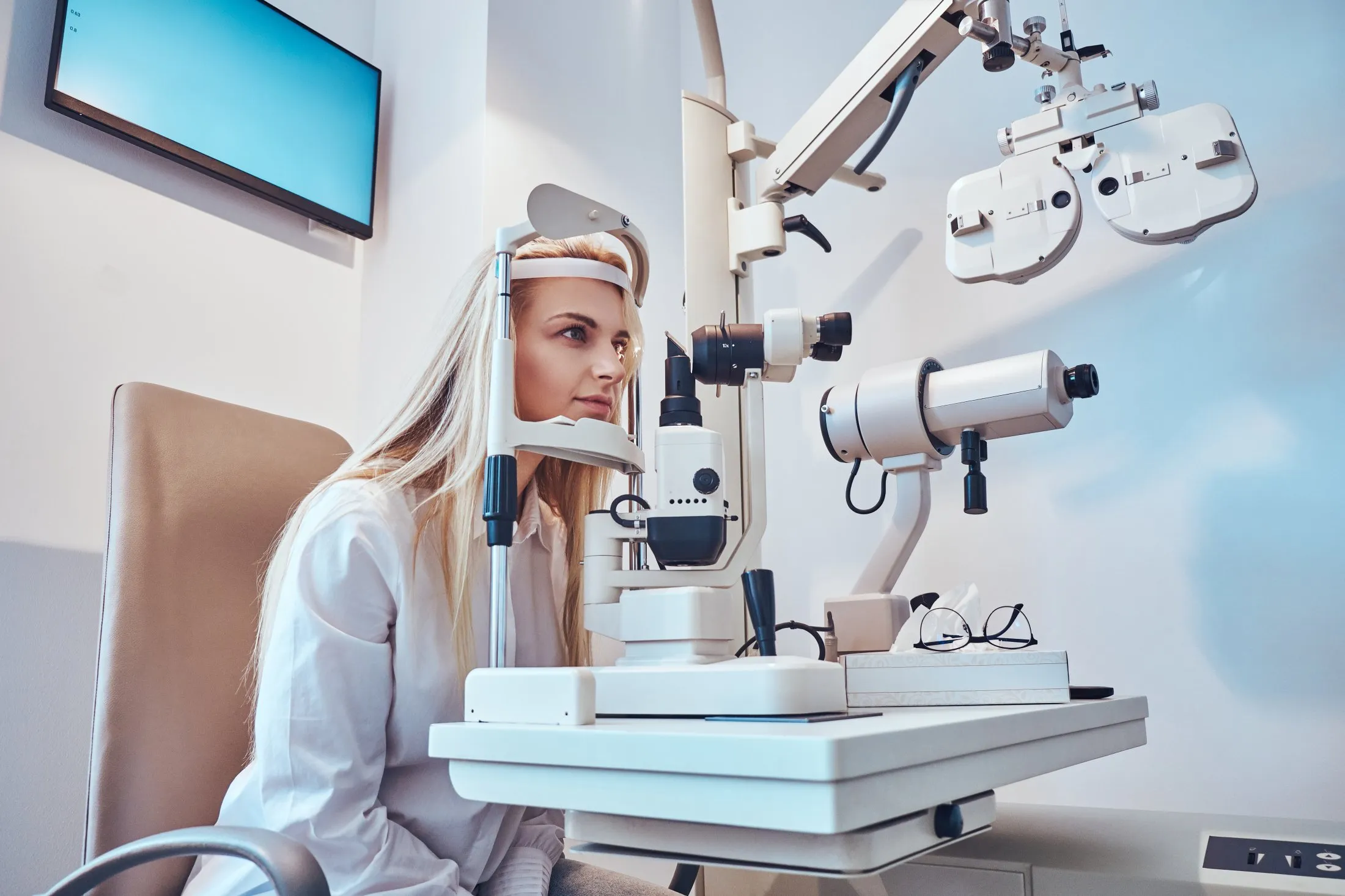 Patient undergoing eye exam with professional optometry equipment