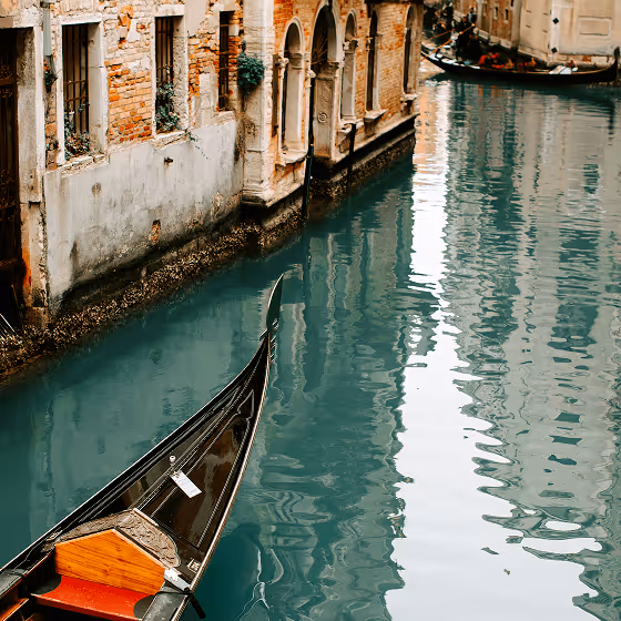 A boat travels along a canal in Venice