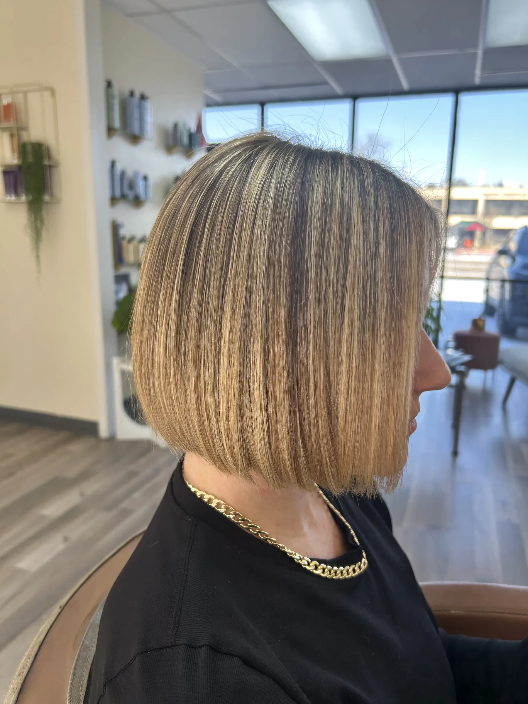 Side view of a sleek blonde bob haircut