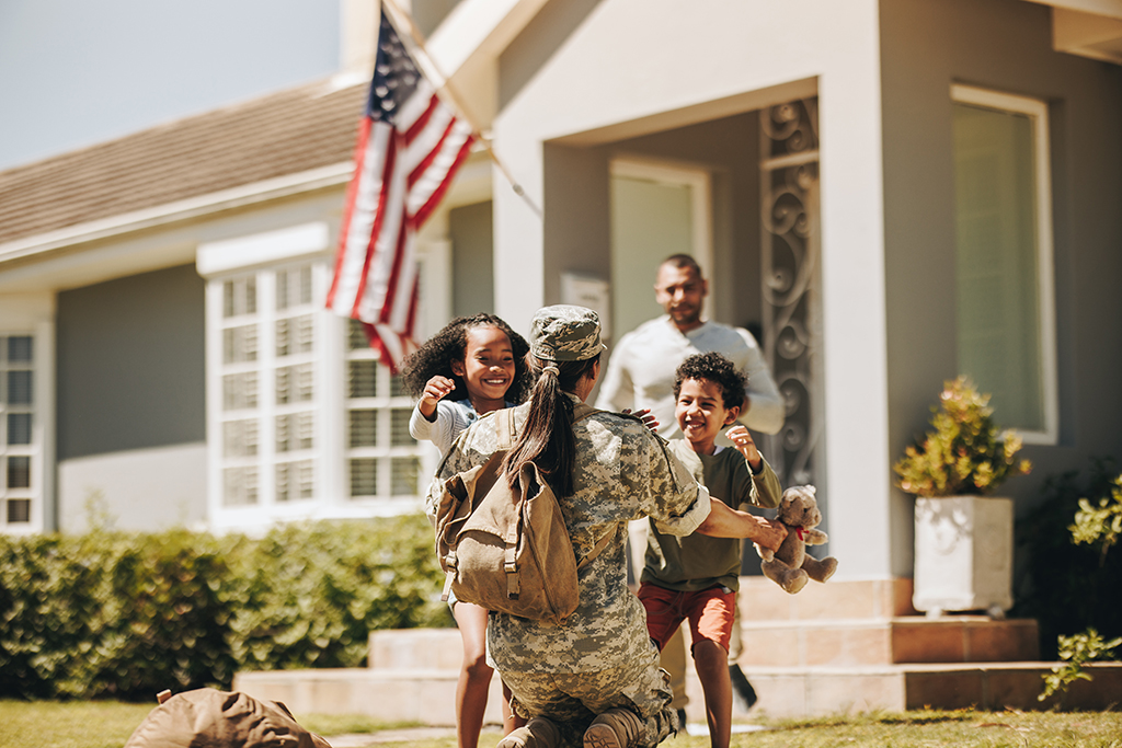 A female soldier is received by her family