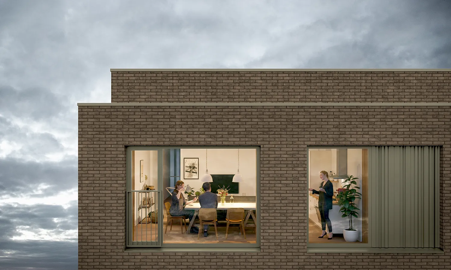 Detail van een modern bakstenen appartementencomplex in de schemering, met mensen zichtbaar in een verlichte eetruimte achter grote ramen.