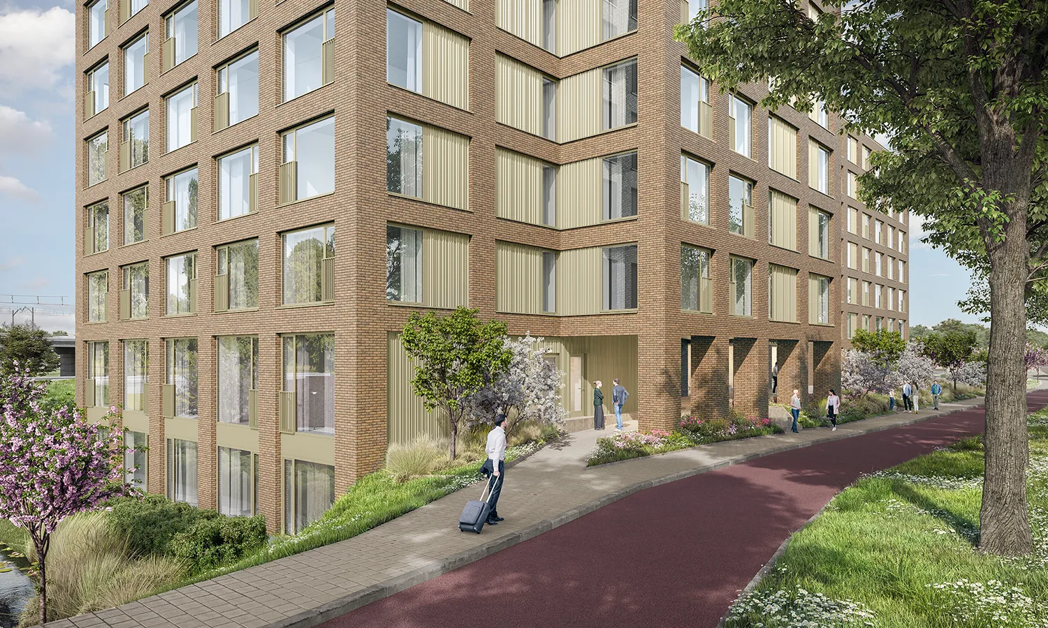 Hoekaanzicht van een modern bakstenen woongebouw met grote ramen, groen aangelegde buitenruimte en mensen die lopen langs een rood fietspad.