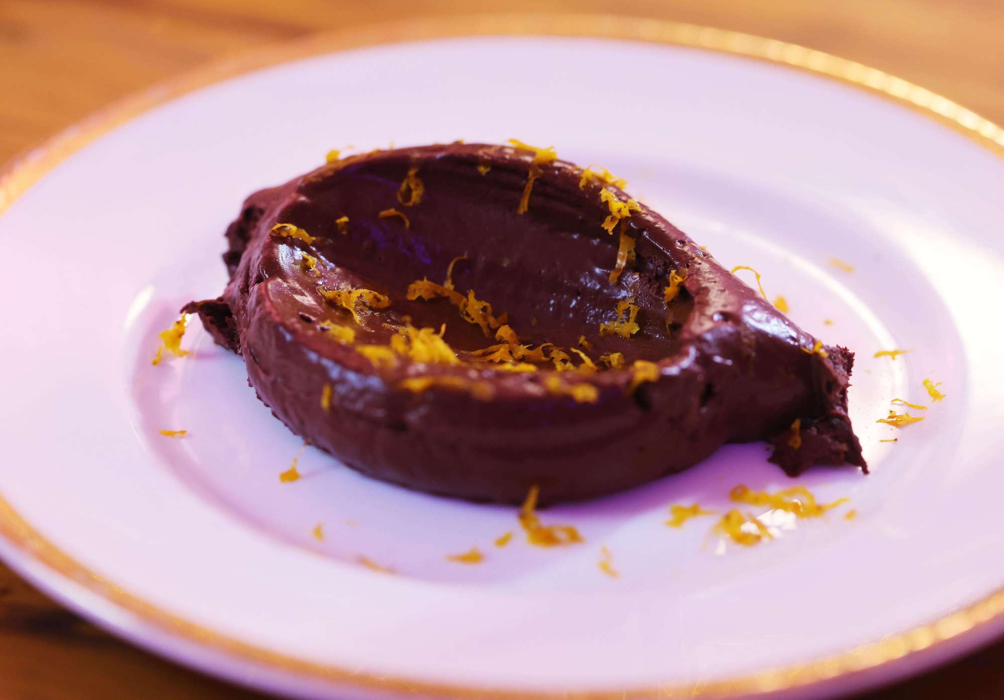 Rich dark chocolate mousse with orange zest by Jack Stein on a white plate