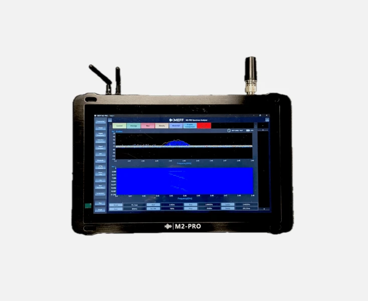 M2-PRO spectrum analyzer with antennae showing frequency and signal strength on its screen.