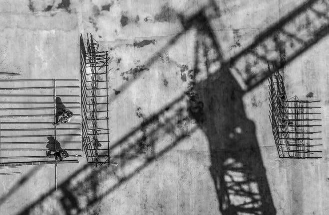 An overhead view of a construction site in black and white.