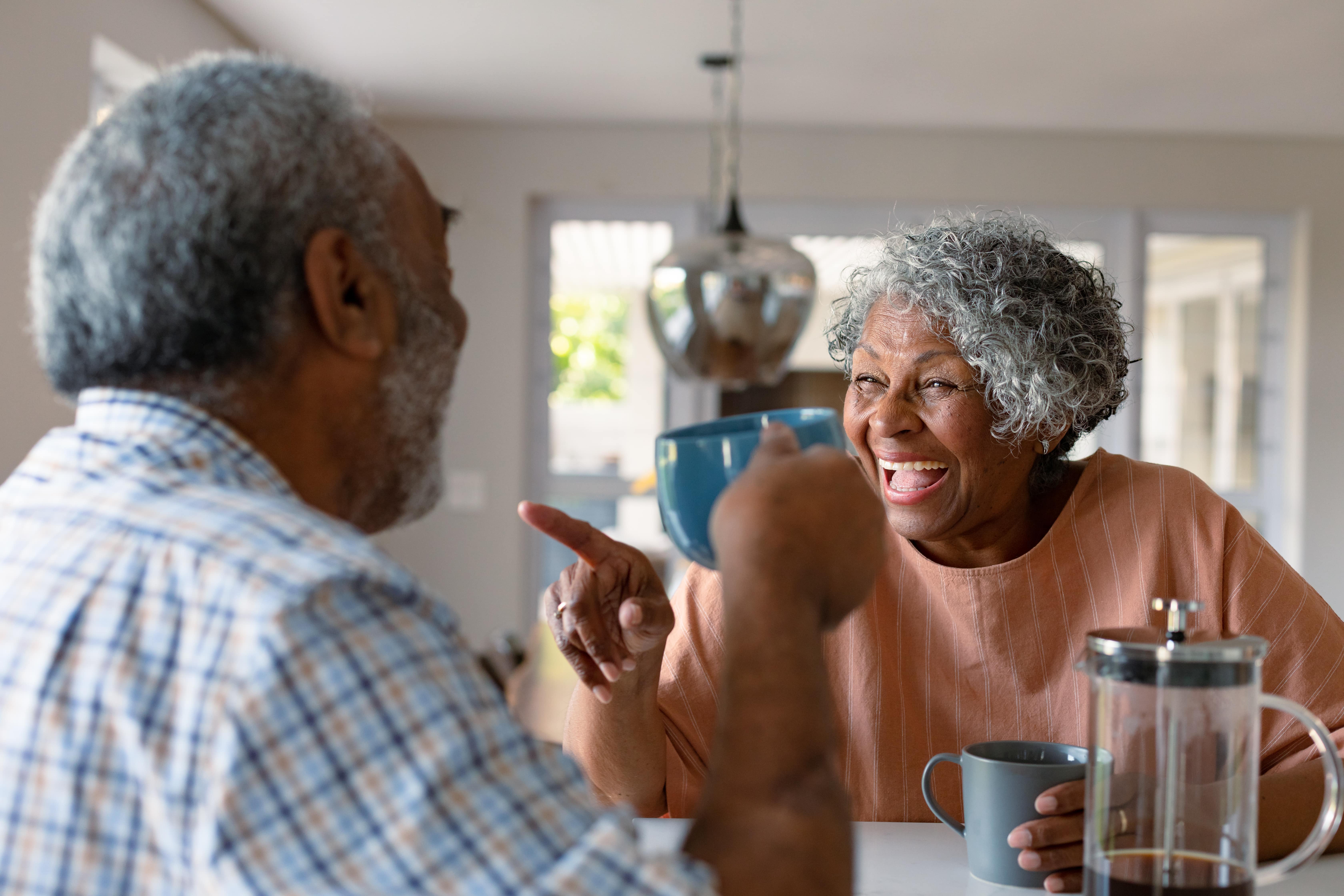 people laughing with coffee stock image