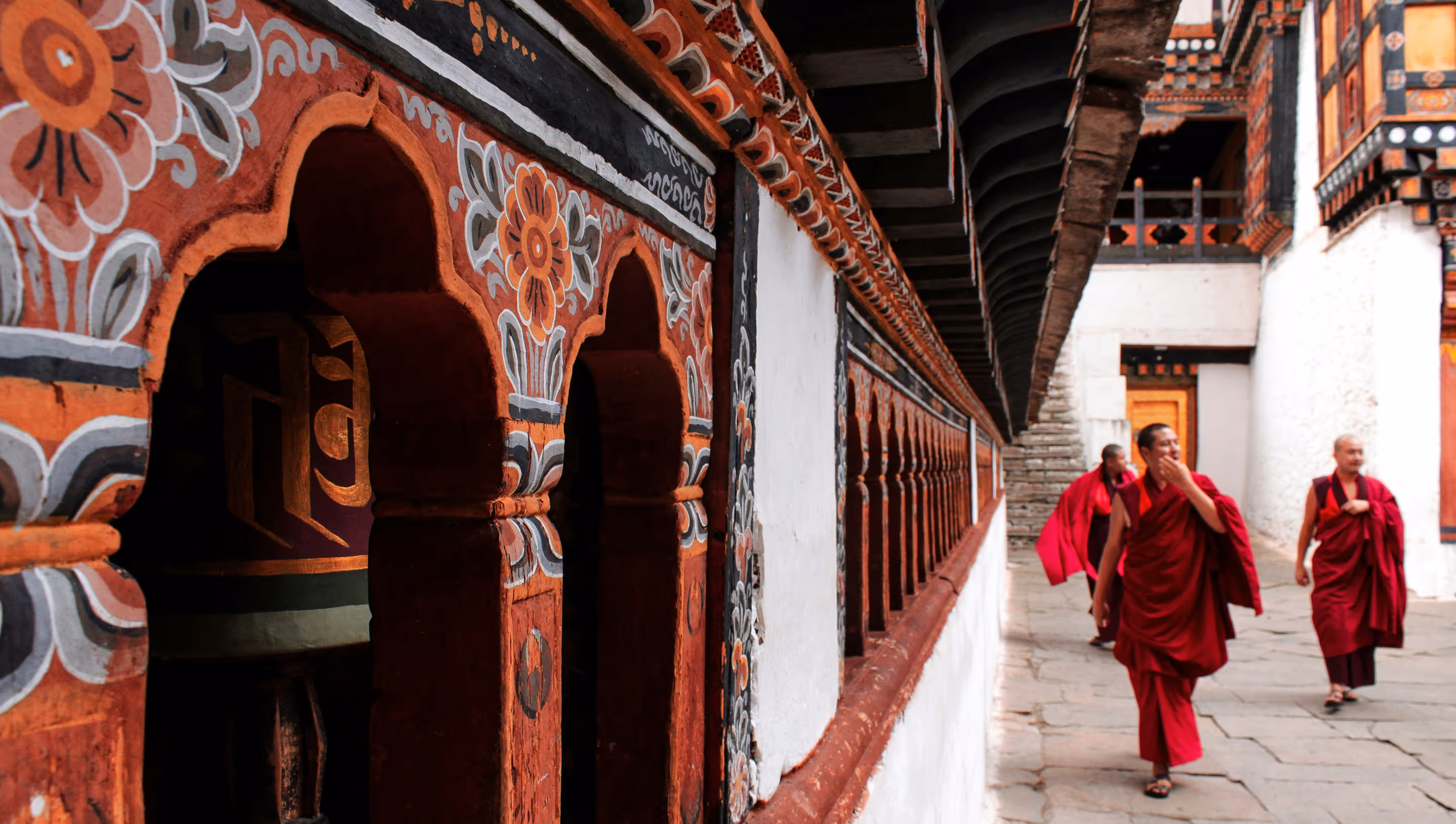 Monks in red robes walking