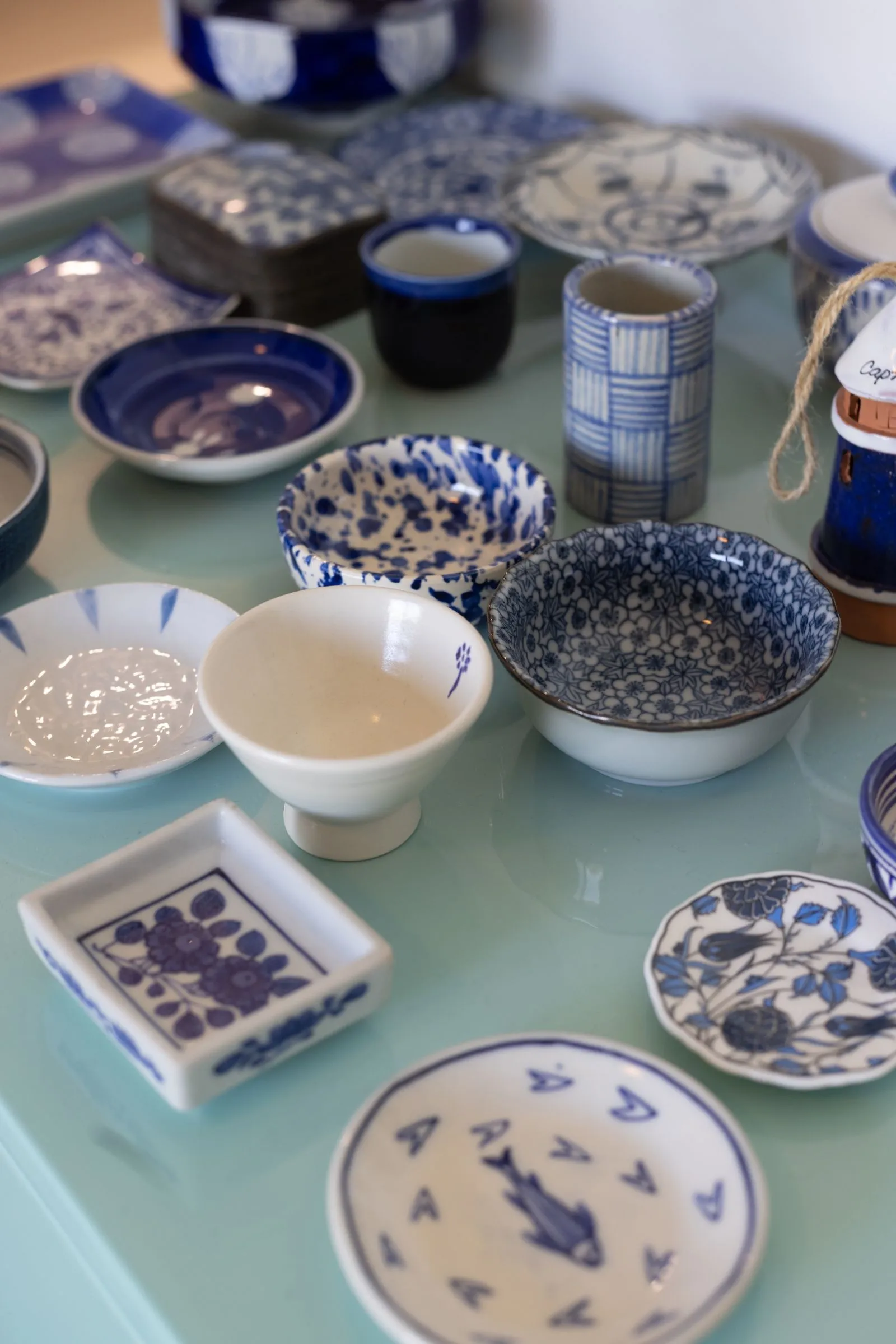Photograph of white and blue ceramics on table.