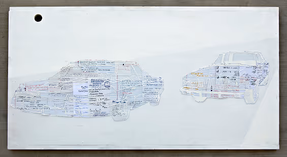 Two transparent sheet cutouts of cars with handwritten notes, placed on a white rectangular board.
