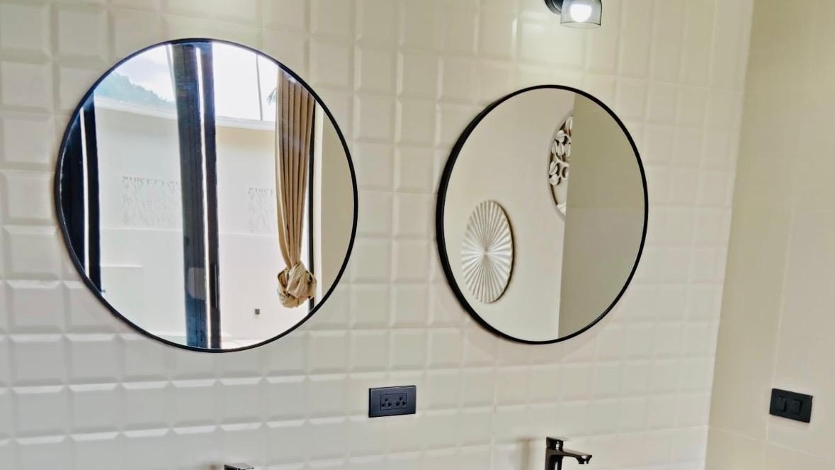 Bathroom with double vanity and round mirrors