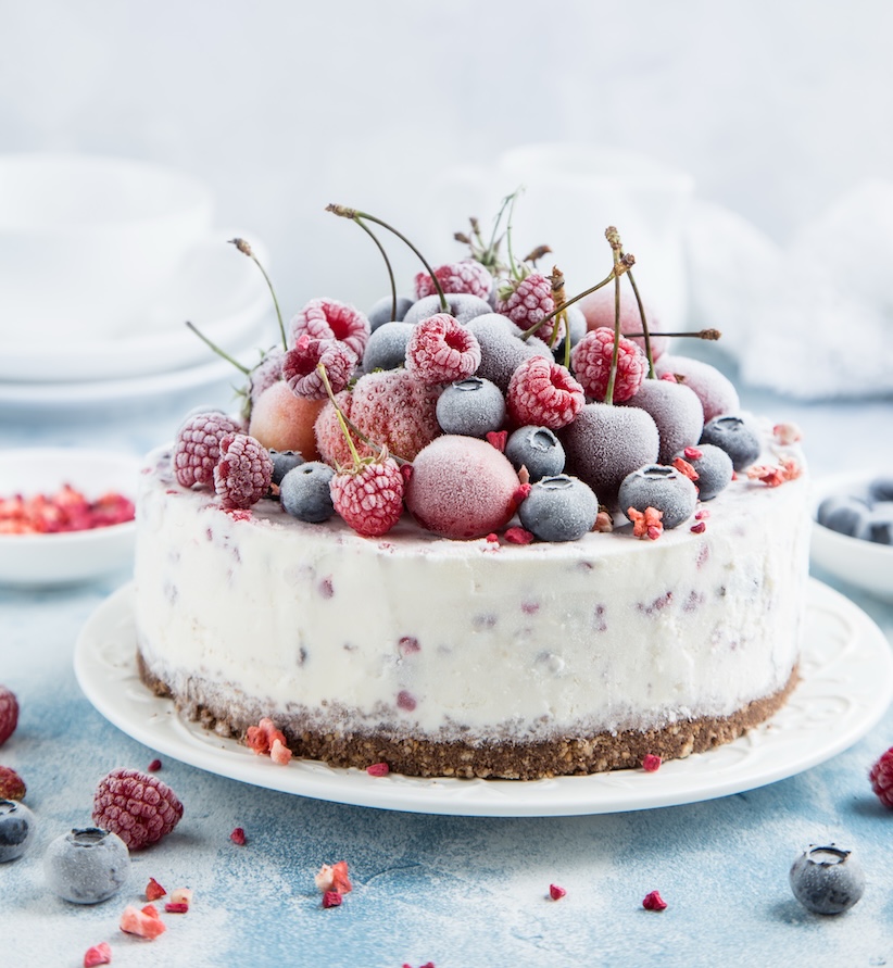 Cremetorte mit gefrosteten Himbeeren, Heidelbeeren und Kirschen