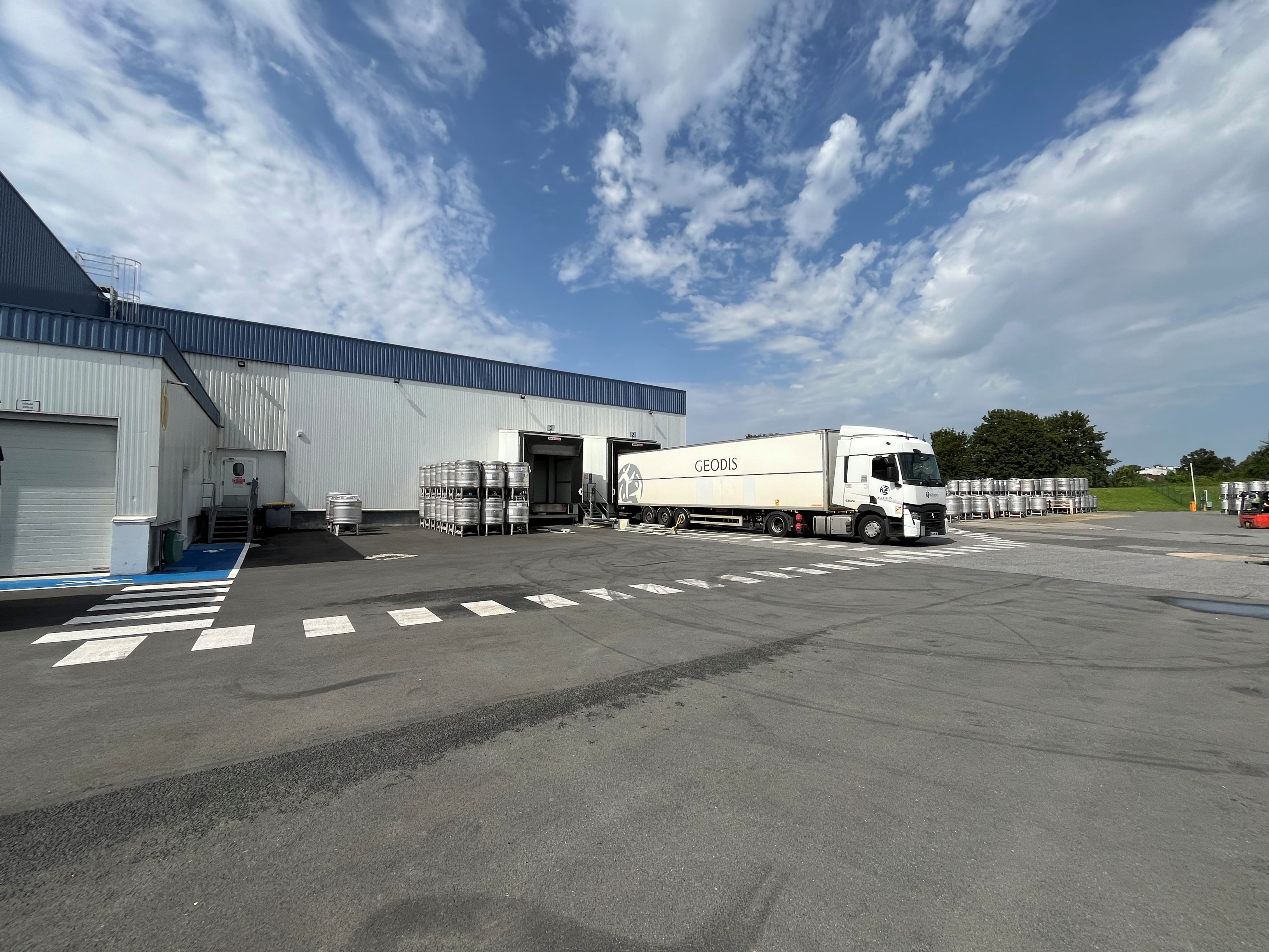 Truck at the loading bay of the AGRANA Fruit plant in France under a cloudy sky