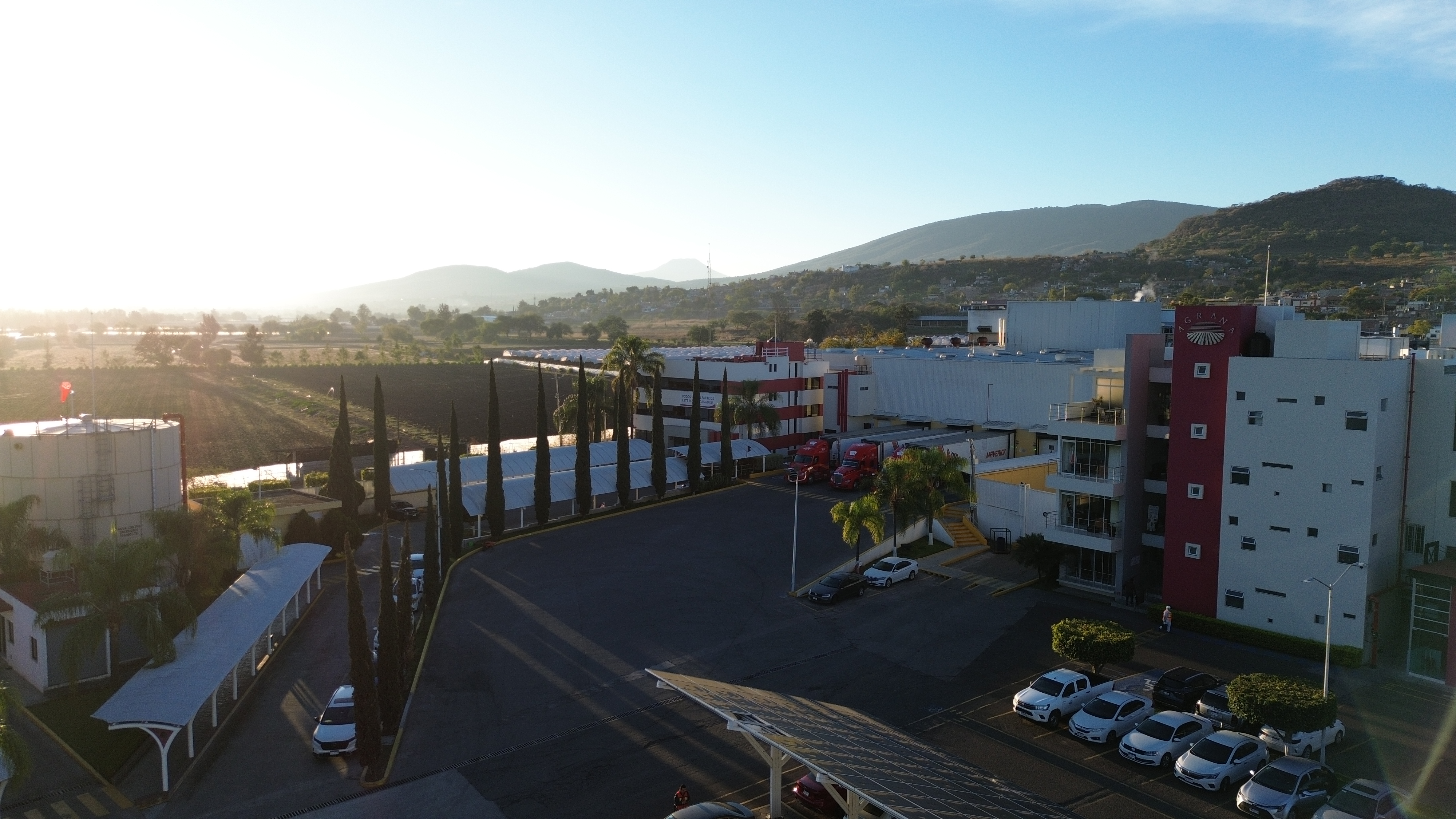 AGRANA Fruit plant in Mexico seen from above at sunrise, with car park and hills behind [no AI]