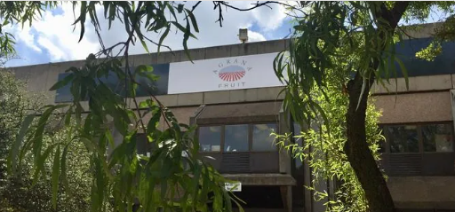 AGRANA Fruit sign on the building facade in South Africa, framed by tree branches