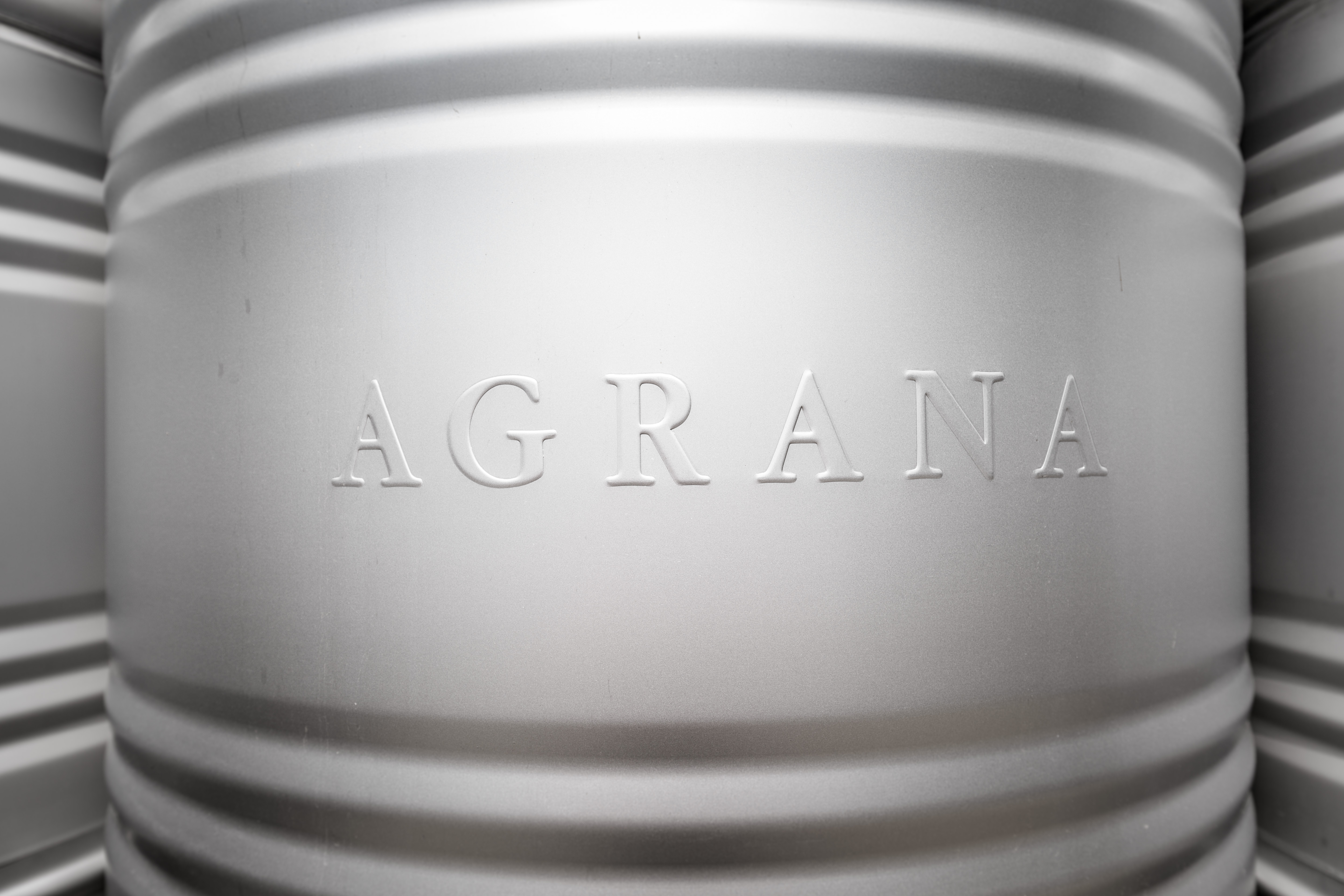 AGRANA lettering embossed on a stainless steel container [no AI]