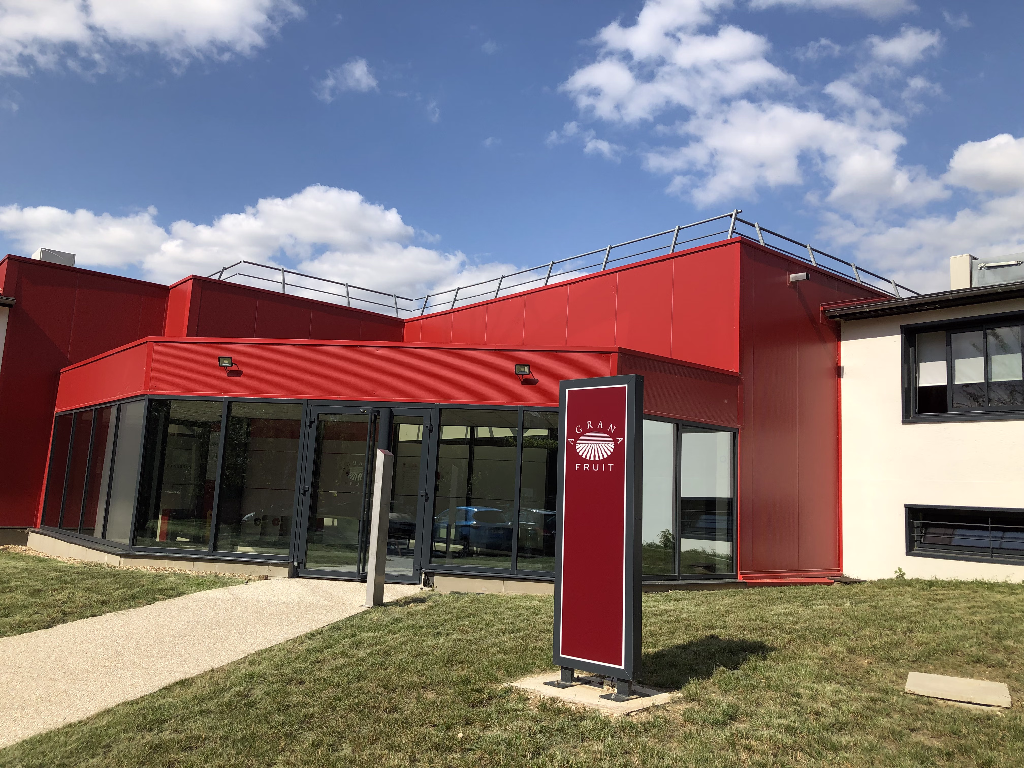 Red entrance of the AGRANA Fruit building in France with an AGRANA Fruit sign in front [no AI]
