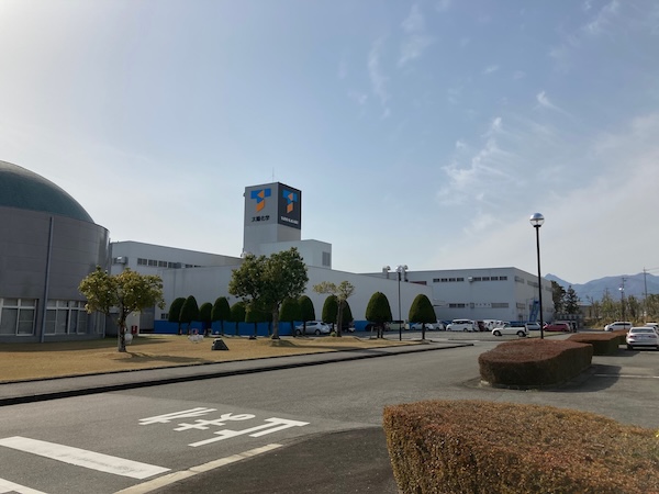 AGRANA Fruit plant in Japan with white production halls, trees and a car park in front [no AI]