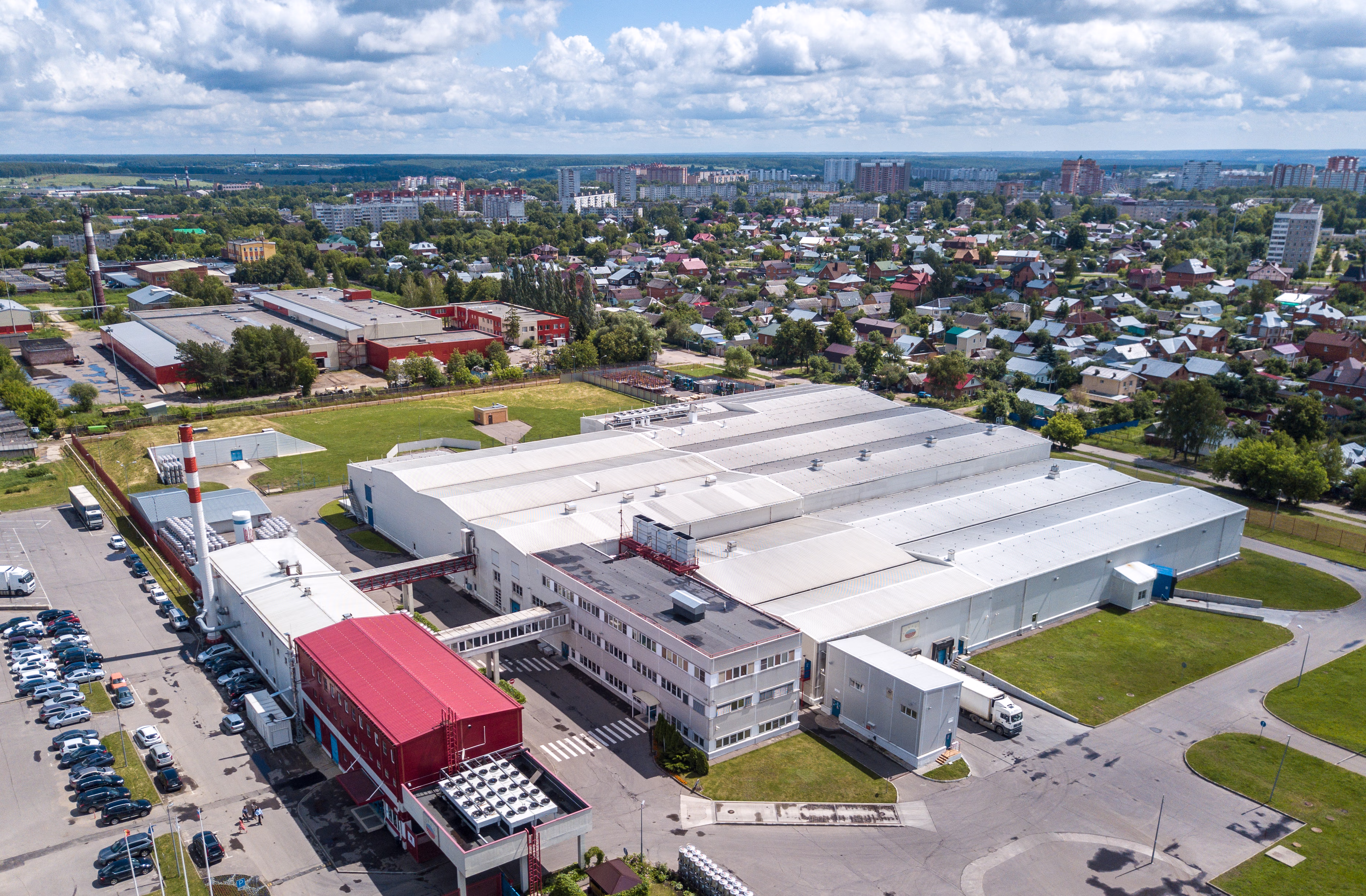 Aerial view of the AGRANA Fruit plant in Serpukhov, Russia, with production halls and the town behind