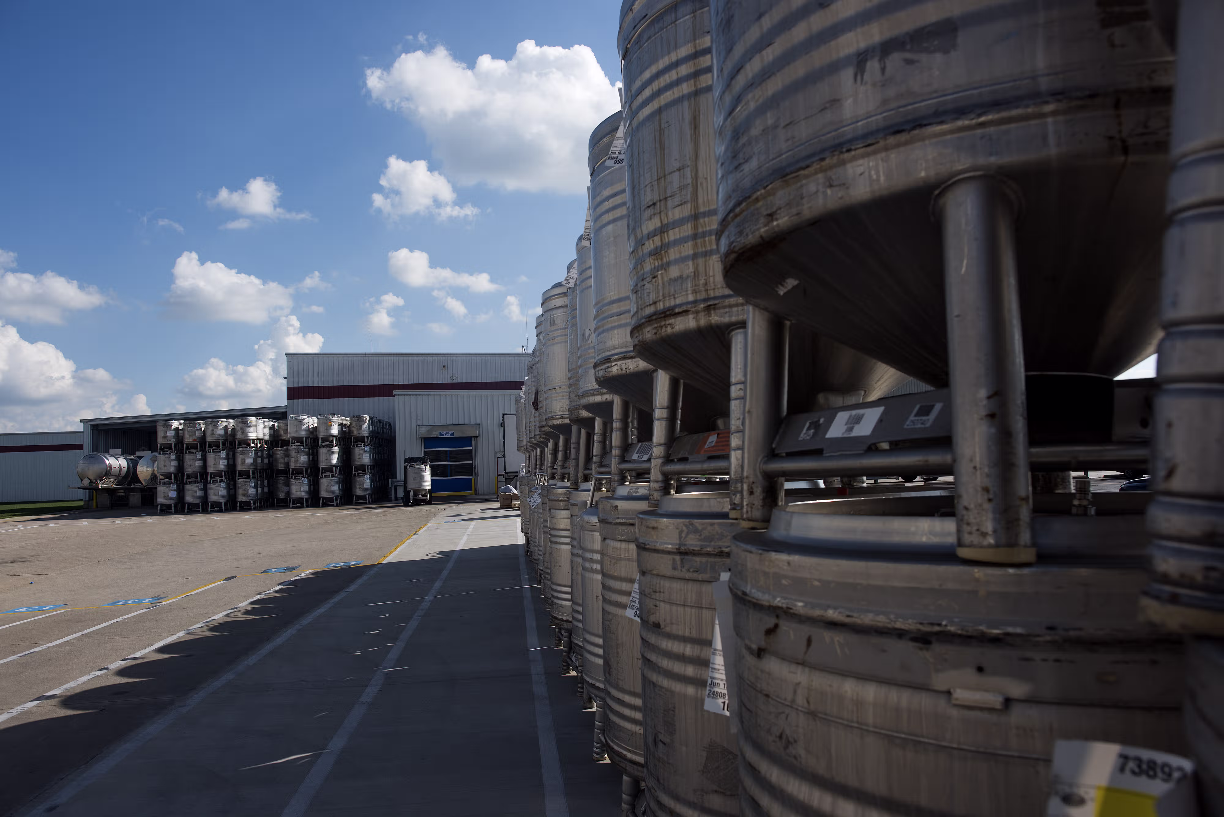 Rows of stacked stainless steel containers in the yard of a US plant [no AI]
