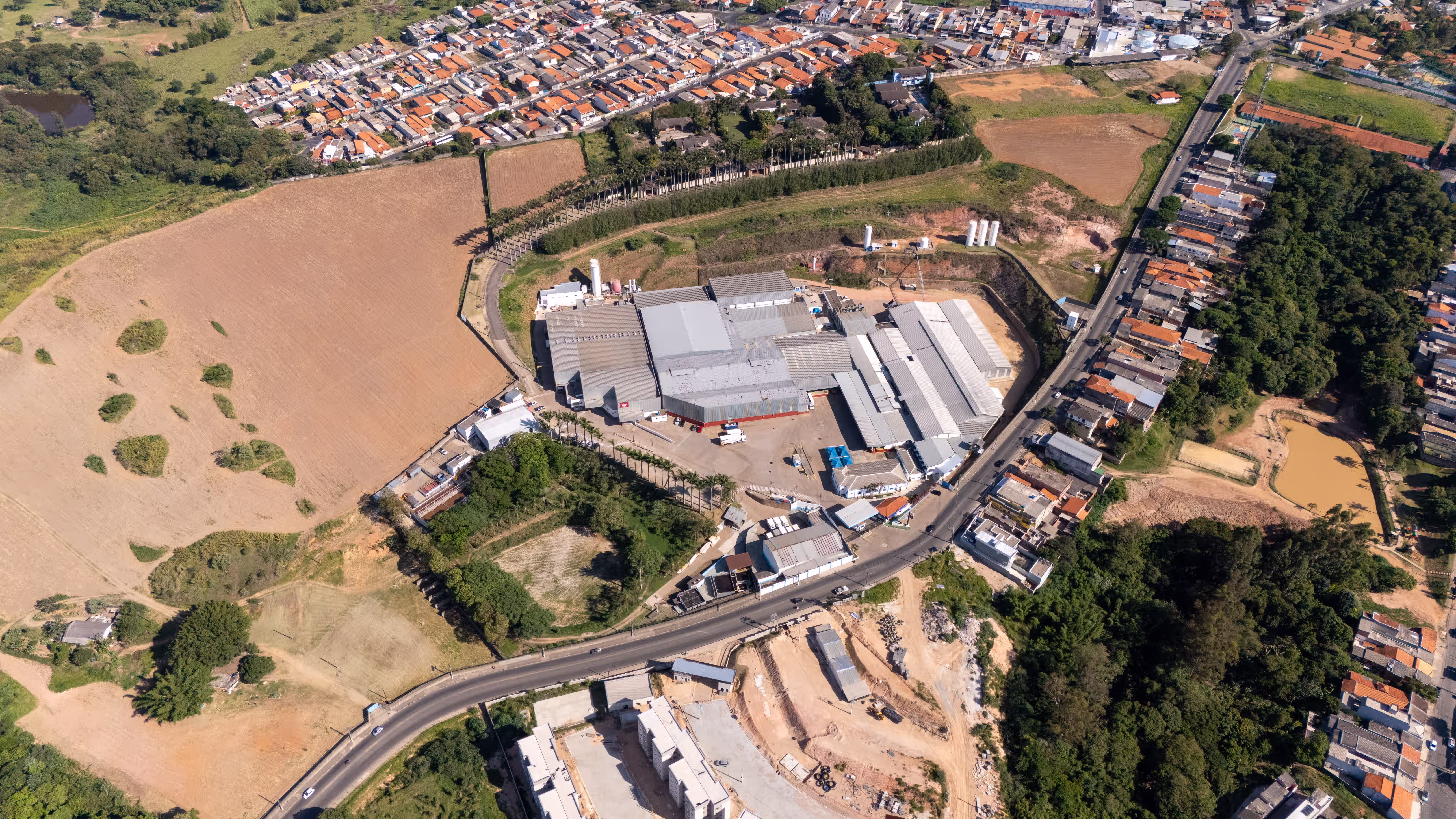 AGRANA Fruit plant in Brazil seen from high above, between farmland and residential areas [no AI]